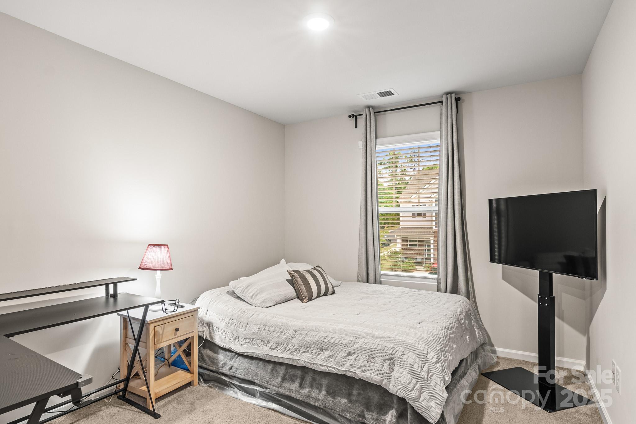 804 Gable Oak Lane Fort Mill, SC 29708 - Photo 20 of 26 a bedroom with a bed tv and table