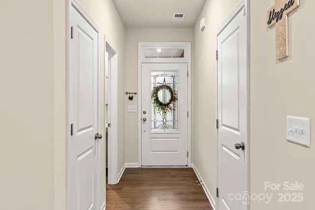 a view of a hallway view with wooden floor and staircase