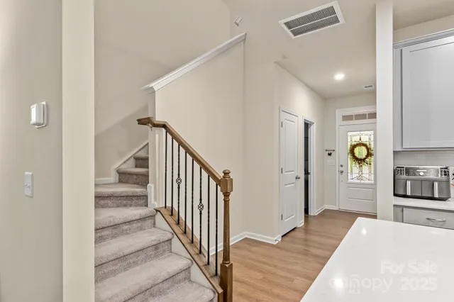 a view of a hallway view with wooden floor and staircase