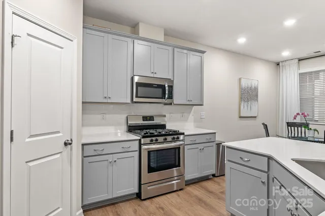 a kitchen with a sink stove and microwave