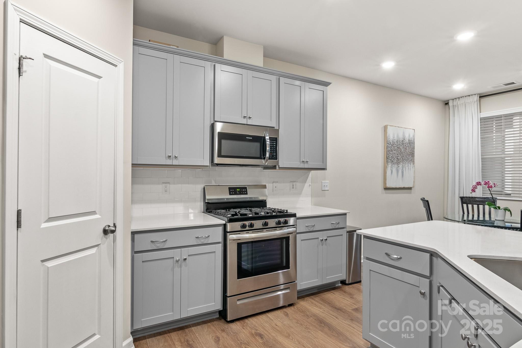 804 Gable Oak Lane Fort Mill, SC 29708 - Photo 9 of 26 a kitchen with a sink stove and microwave