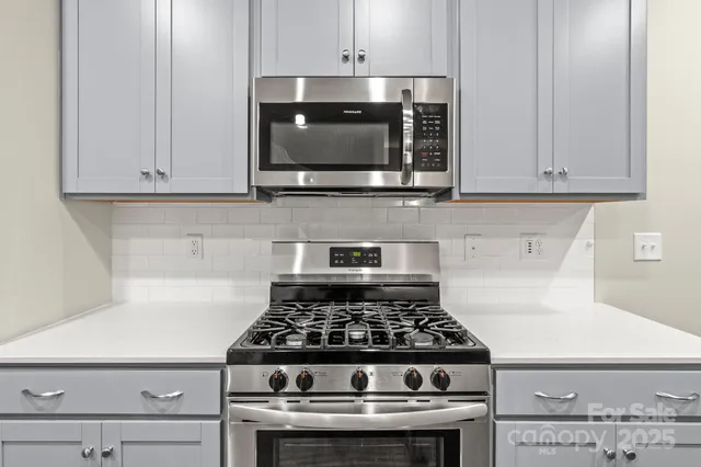 a stove top oven sitting inside of a kitchen