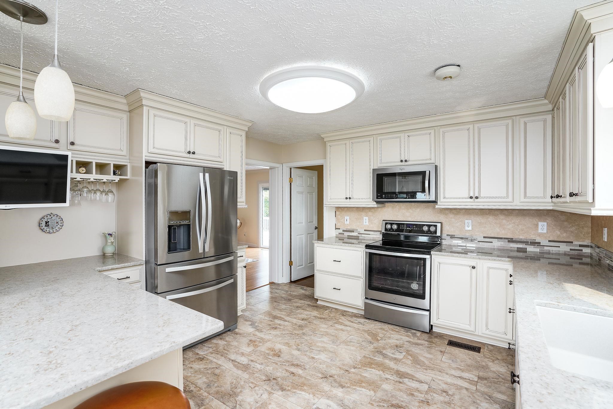 400 Quick's Mill Road Verona, VA 24482 - Photo 15 of 75 a kitchen with stainless steel appliances granite countertop a stove a sink and a microwave