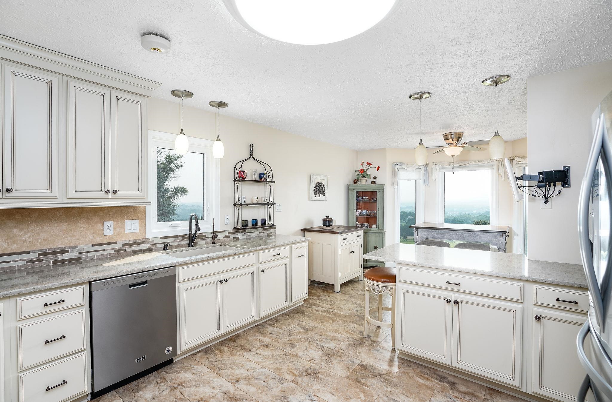 400 Quick's Mill Road Verona, VA 24482 - Photo 19 of 75 a large white kitchen with a stove a sink dishwasher and a refrigerator with white cabinets