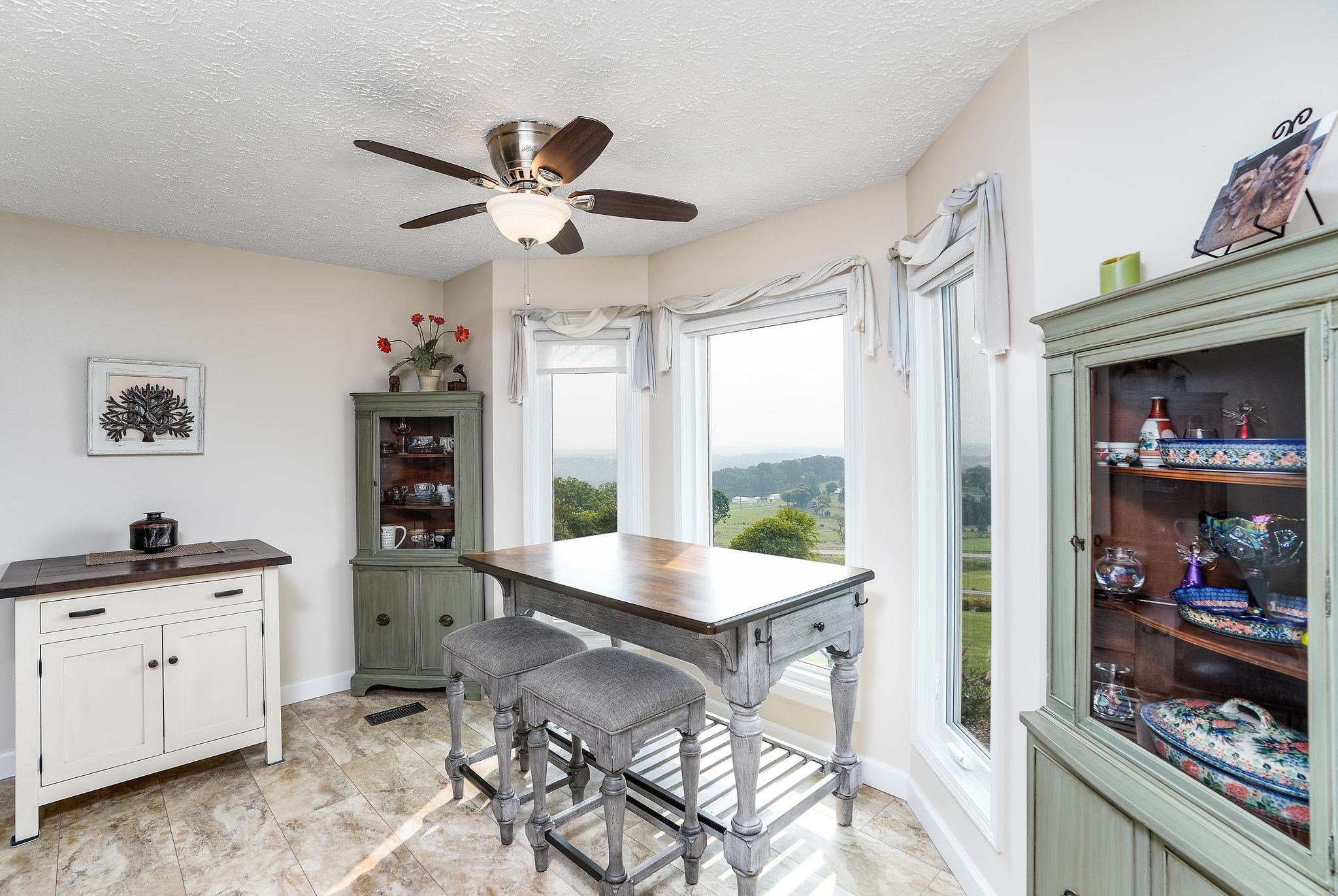 400 Quick's Mill Road Verona, VA 24482 - Photo 24 of 75 a kitchen with stainless steel appliances kitchen island granite countertop a refrigerator a sink a dining table and chairs with wooden floor
