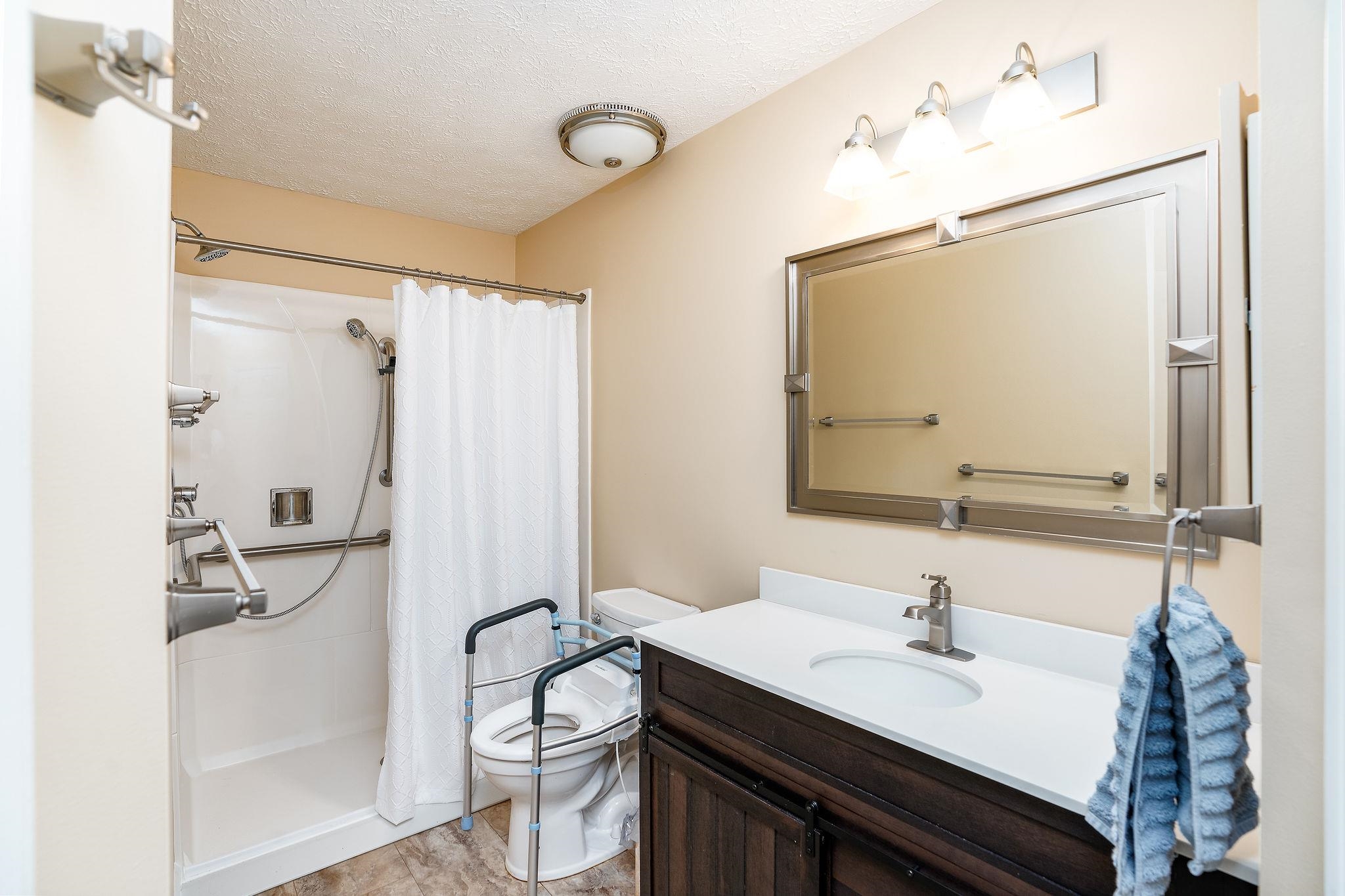 400 Quick's Mill Road Verona, VA 24482 - Photo 44 of 75 a bathroom with a granite countertop sink toilet and shower