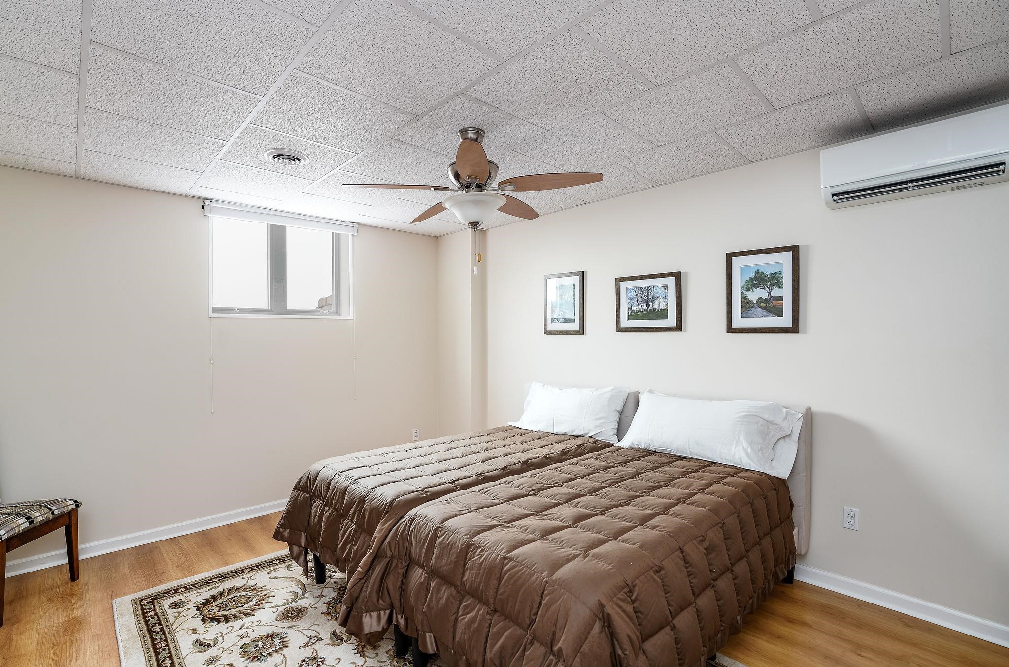 400 Quick's Mill Road Verona, VA 24482 - Photo 49 of 75 a bedroom with a large bed and a chandelier