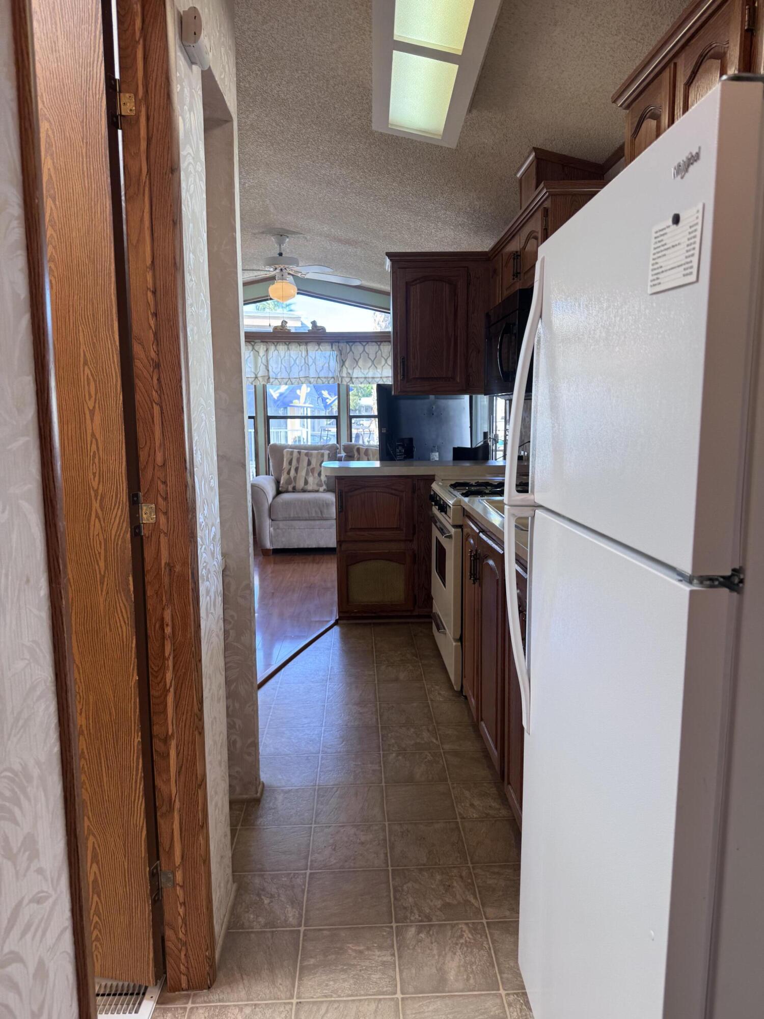 84136 Ave 44, Unit 178 Indio, CA 92203 - Photo 14 of 23 a kitchen with a refrigerator and a sink