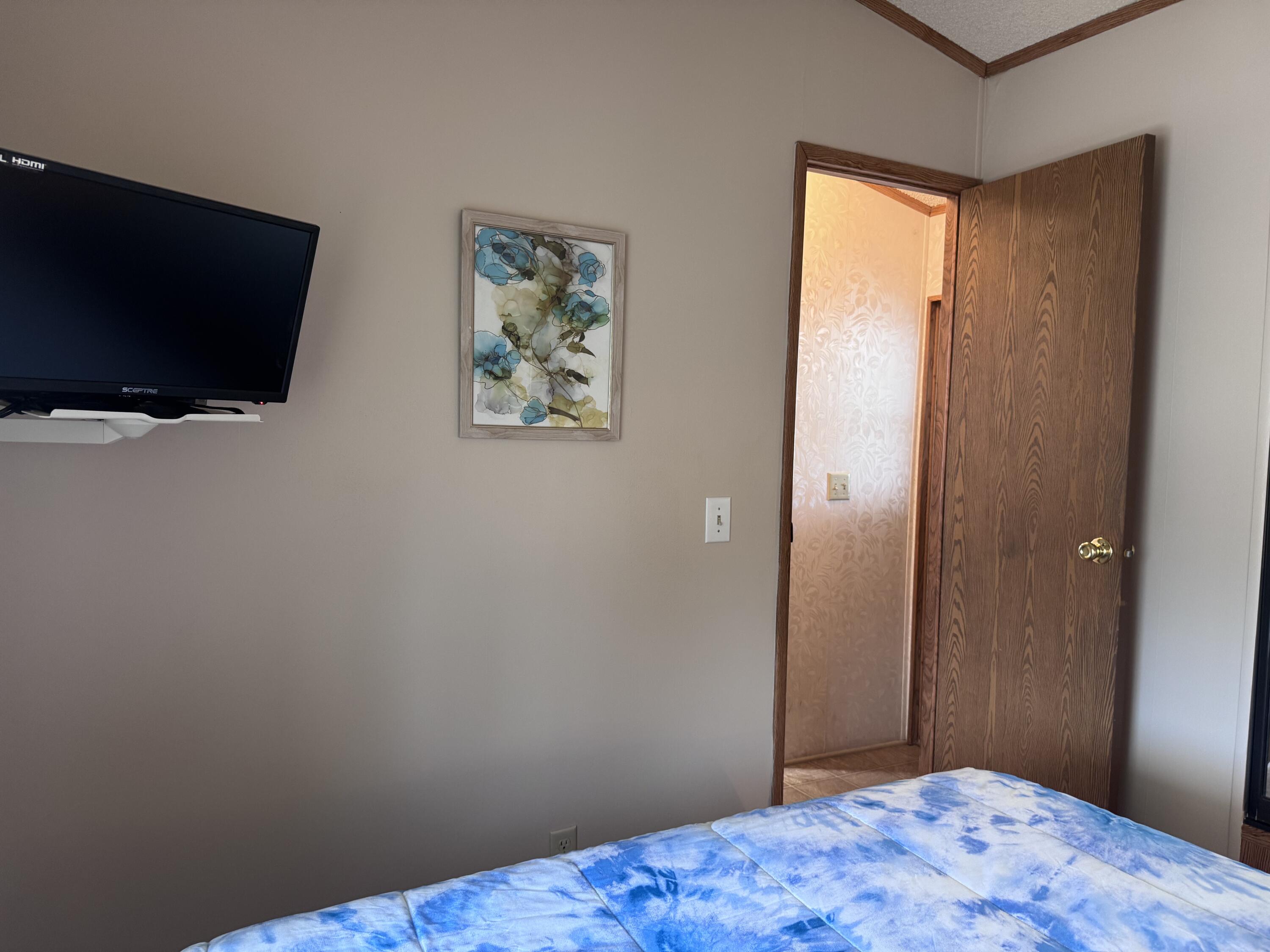 84136 Ave 44, Unit 178 Indio, CA 92203 - Photo 17 of 23 a bedroom with a bed and a flat screen tv