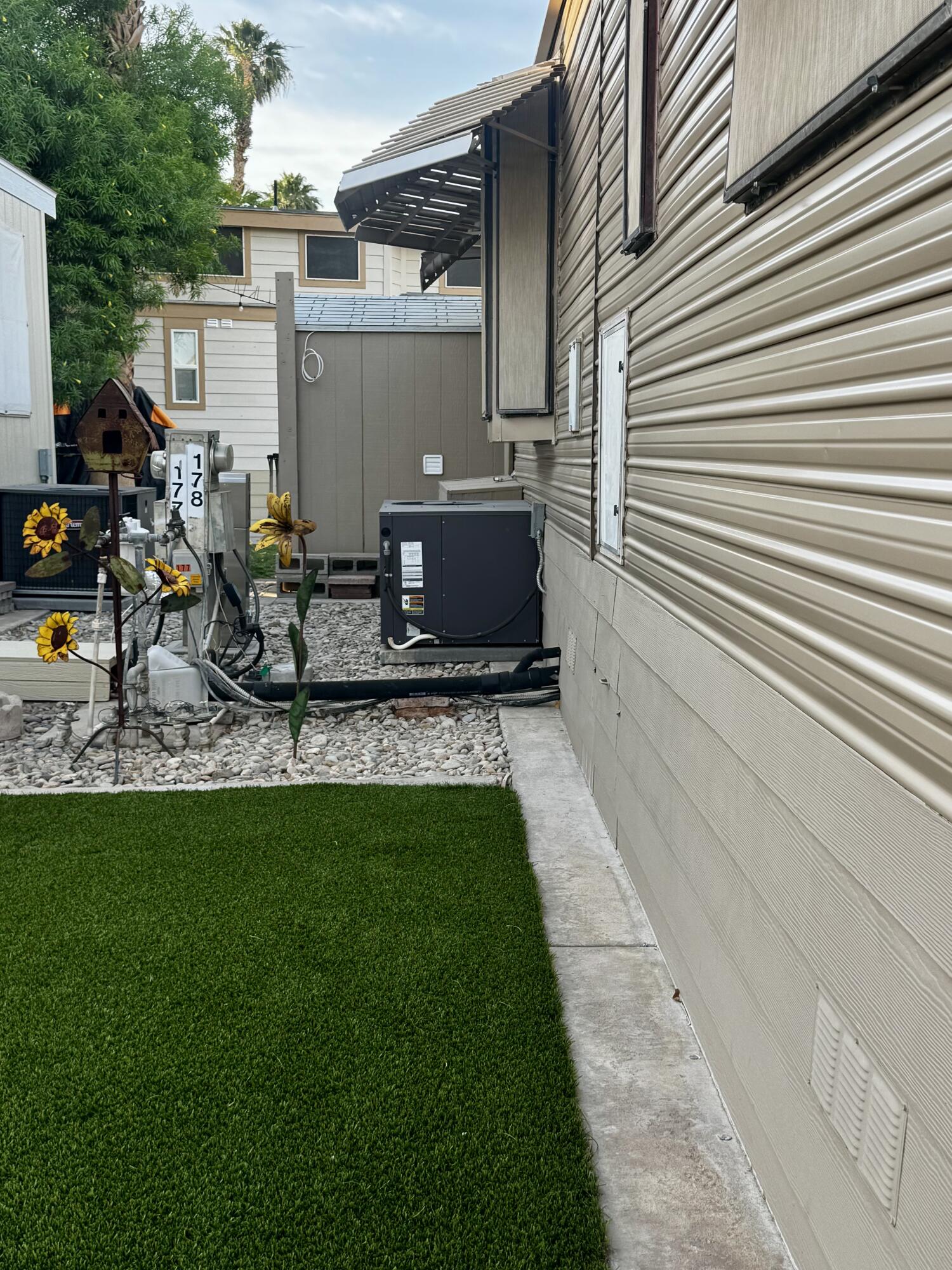 84136 Ave 44, Unit 178 Indio, CA 92203 - Photo 5 of 23 a view of backyard with a chair and potted plants