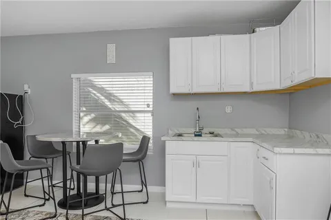 a kitchen with a sink cabinets and window