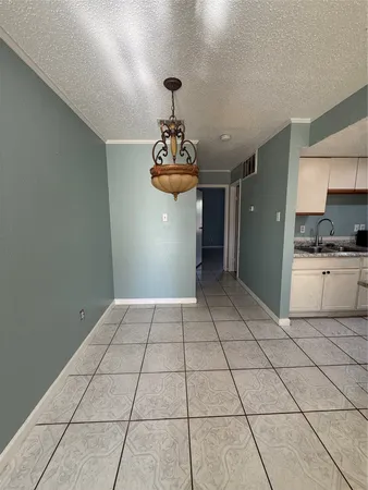 a view of a kitchen with a sink and cabinets