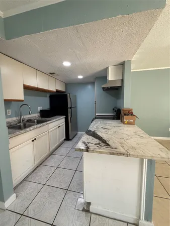 a kitchen with stainless steel appliances kitchen island granite countertop a sink and cabinets