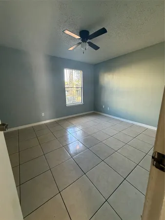 a view of an empty room and a window