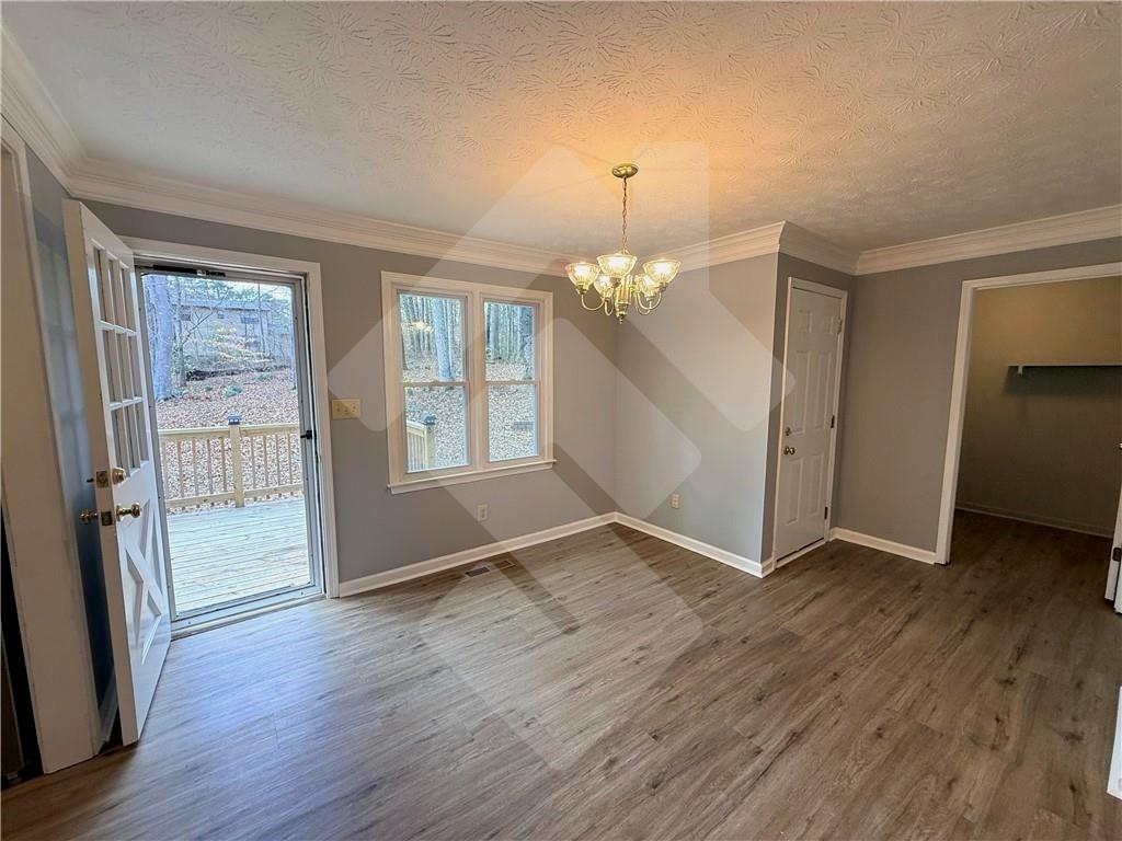 4502 Alder Lane Powder Springs, GA 30127 - Photo 12 of 64 an empty room with wooden floor and staircase