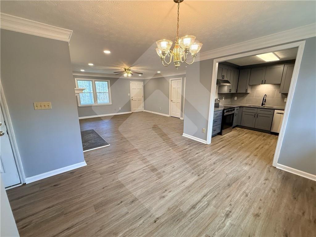 4502 Alder Lane Powder Springs, GA 30127 - Photo 22 of 64 a view of a room with wooden floor and chandelier