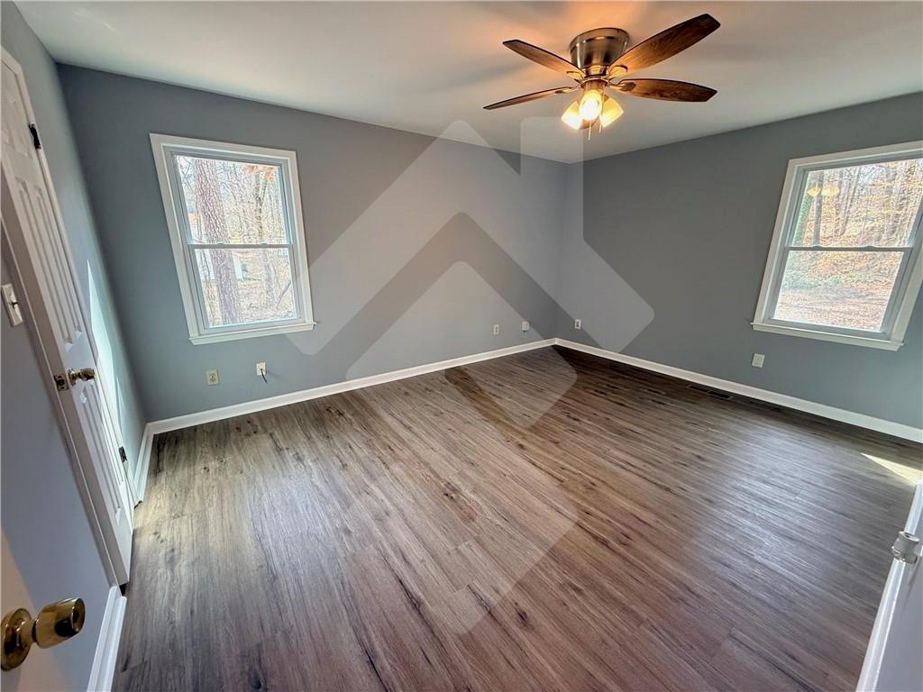 4502 Alder Lane Powder Springs, GA 30127 - Photo 27 of 64 an empty room with wooden floor and windows