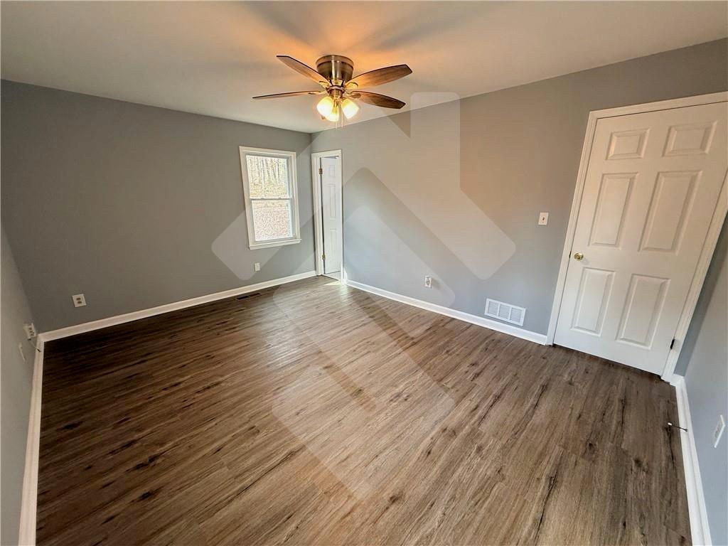 4502 Alder Lane Powder Springs, GA 30127 - Photo 28 of 64 wooden floor in an empty room with a window