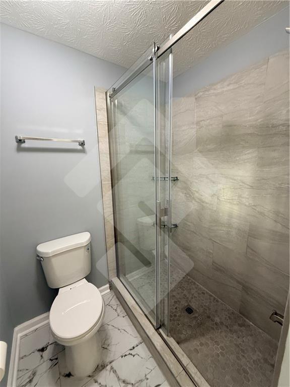 4502 Alder Lane Powder Springs, GA 30127 - Photo 31 of 64 a bathroom with a toilet and a shower