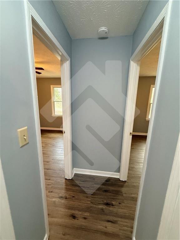 4502 Alder Lane Powder Springs, GA 30127 - Photo 35 of 64 a view of a hallway with wooden floor and a livingroom