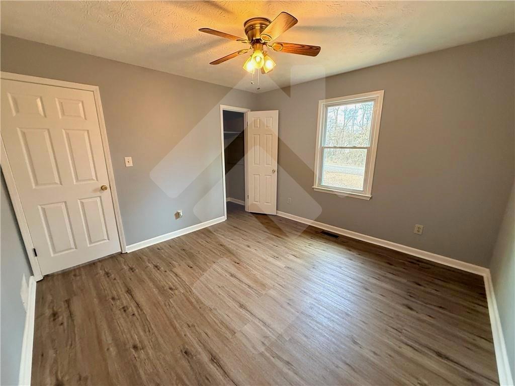4502 Alder Lane Powder Springs, GA 30127 - Photo 37 of 64 wooden floor in an empty room with a window