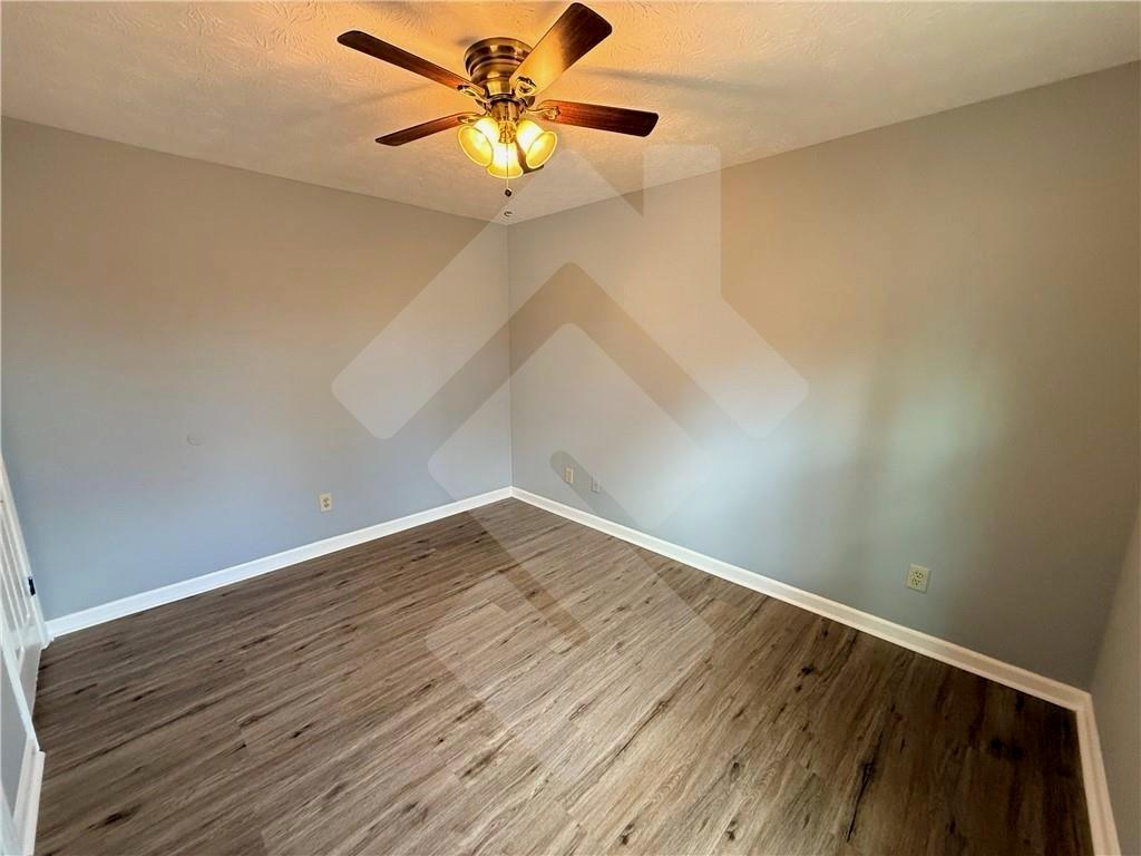 4502 Alder Lane Powder Springs, GA 30127 - Photo 43 of 64 an empty room with wooden floor fan and windows