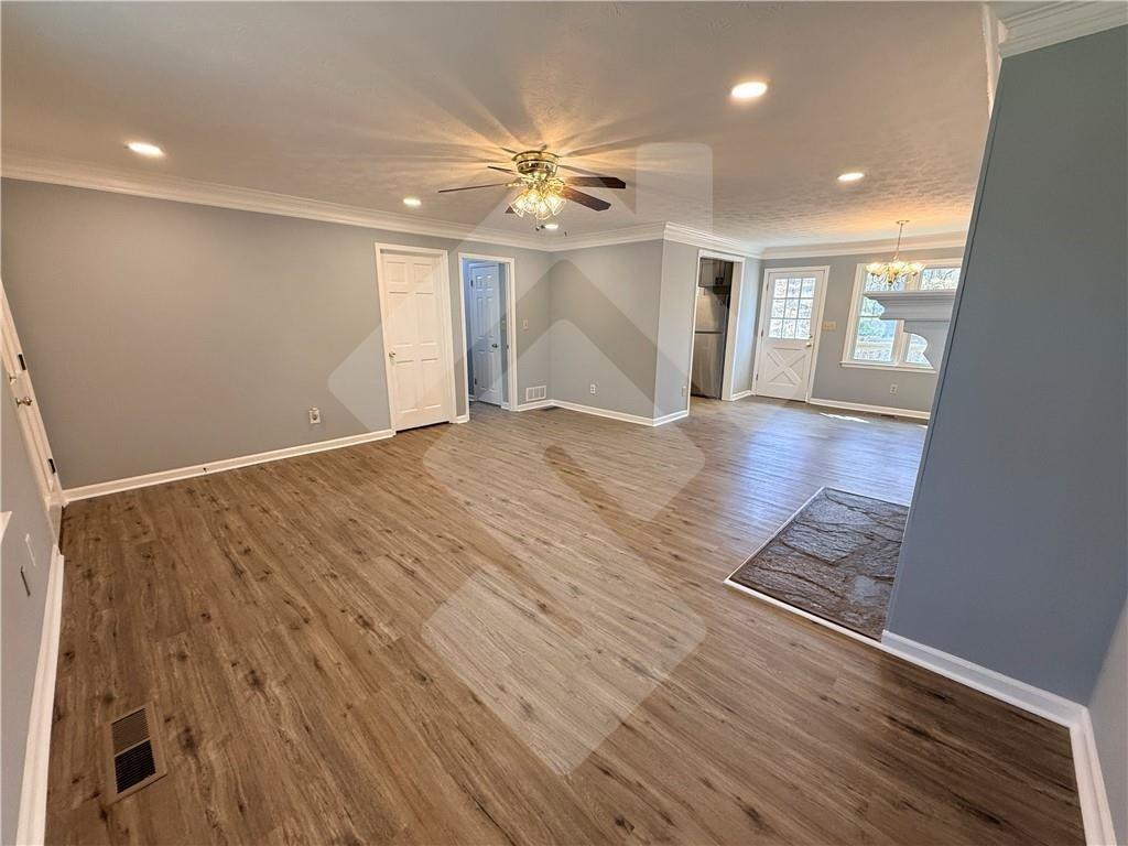 4502 Alder Lane Powder Springs, GA 30127 - Photo 5 of 64 a view of an empty room with wooden floor and a window