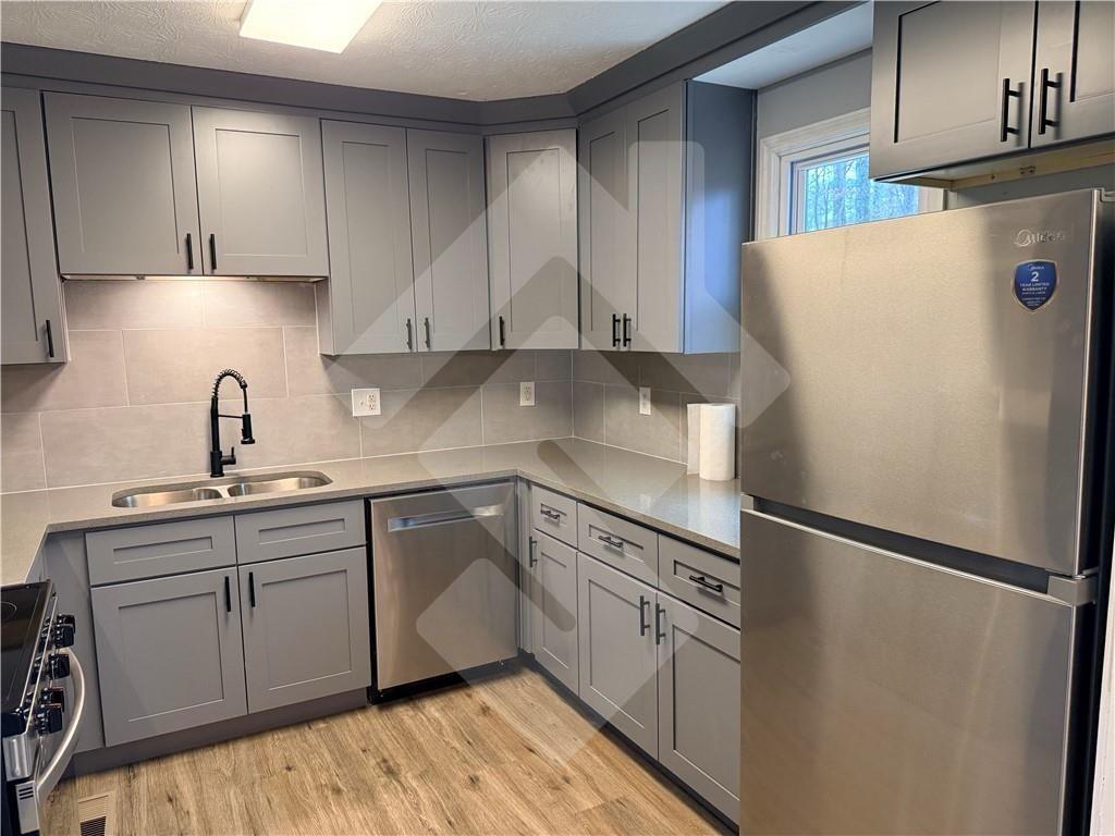 4502 Alder Lane Powder Springs, GA 30127 - Photo 10 of 64 a kitchen with stainless steel appliances a refrigerator sink and cabinets