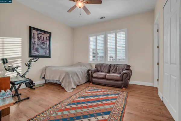 a bedroom with furniture and a rug