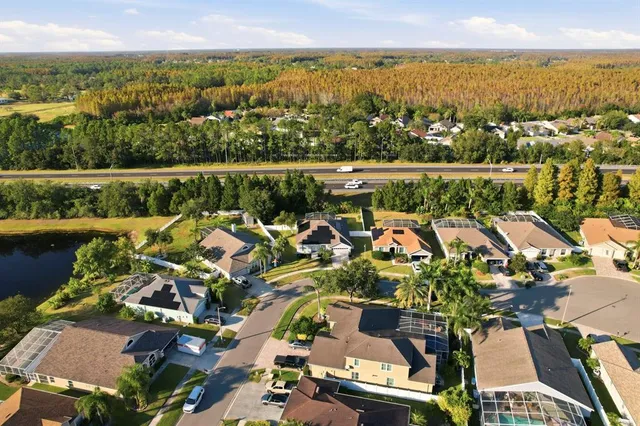 an aerial view of lake and residential houses with outdoor space