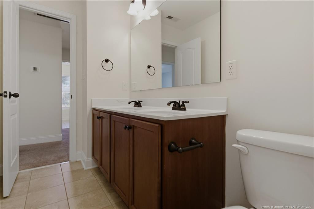182 Valley Stream Road Spring Lake, NC 28390 - Photo 22 of 33 a bathroom with a sink a toilet and shower