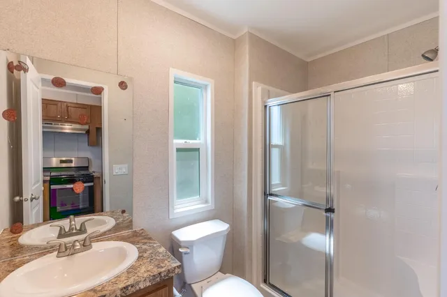 a bathroom with a sink toilet and shower