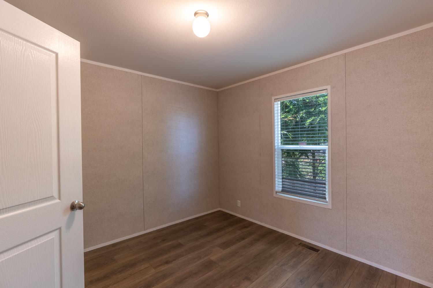 4610 Gateway Road, Unit 13 Bethel Island, CA 94511 - Photo 14 of 17 an empty room with wooden floor and windows