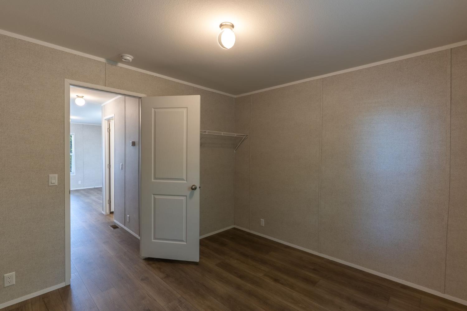 4610 Gateway Road, Unit 13 Bethel Island, CA 94511 - Photo 16 of 17 an empty room with wooden floor and windows