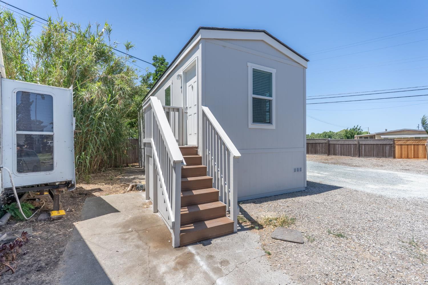 4610 Gateway Road, Unit 13 Bethel Island, CA 94511 - Photo 2 of 17 a view of a house with backyard and trees