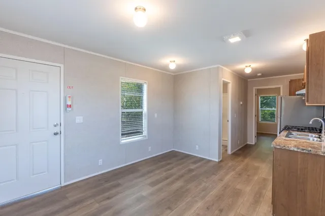 a view of kitchen and wooden floor