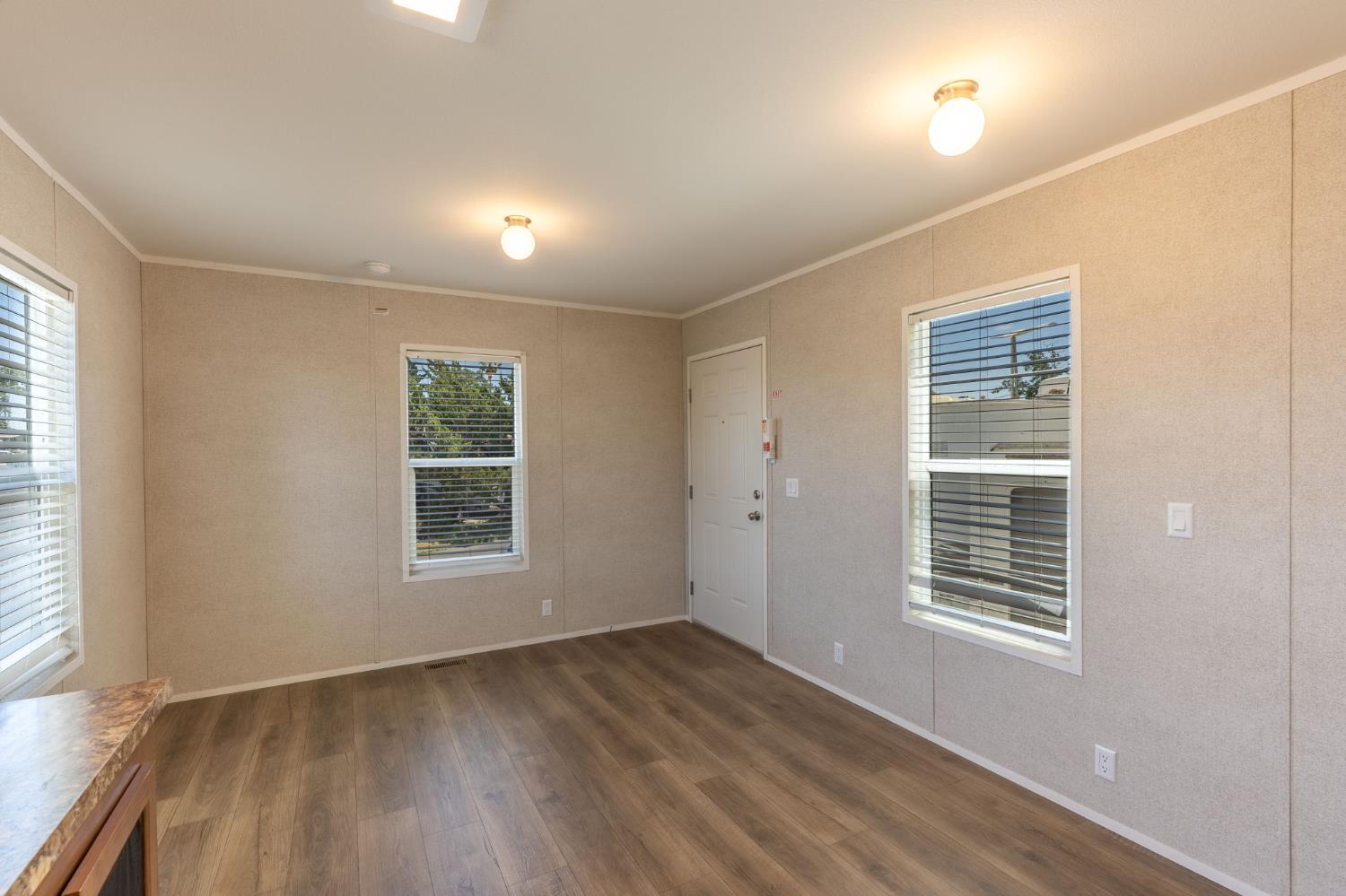 4610 Gateway Road, Unit 13 Bethel Island, CA 94511 - Photo 8 of 17 an empty room with wooden floor and windows