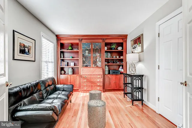 a living room with furniture a rug and a book shelf