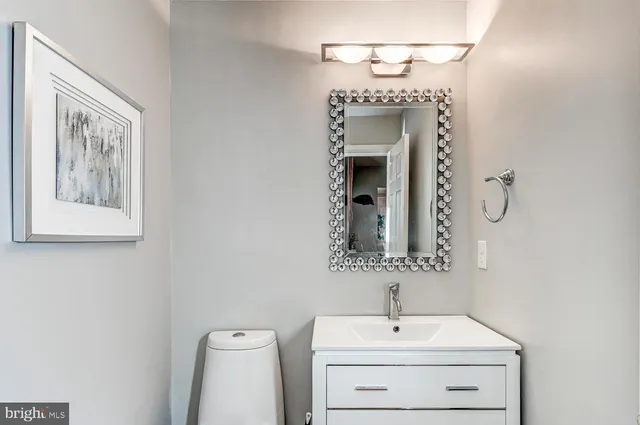 a bathroom with a toilet sink and mirror