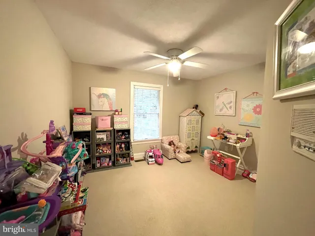 a bedroom with furniture a chandelier and a window