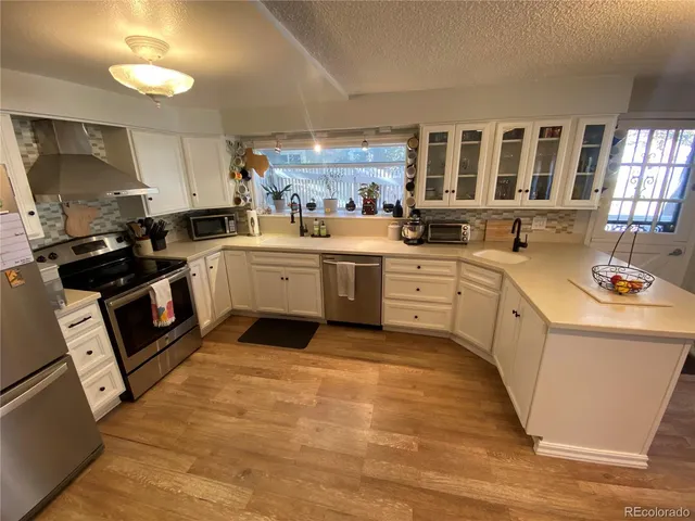 a kitchen with a sink stove and cabinets