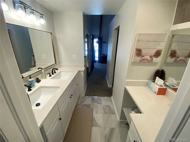 a bathroom with a sink vanity granite tub and shower