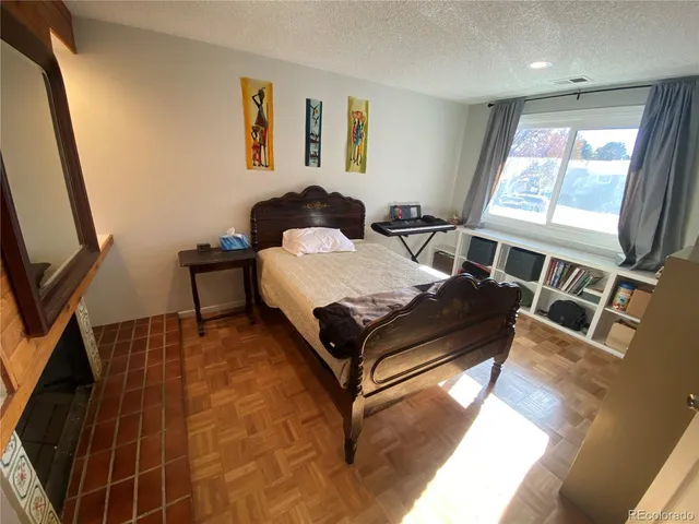 a bedroom with a bed window and mirror