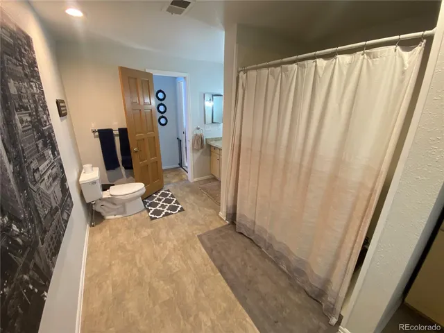 a view of a bedroom with furniture and wooden floor