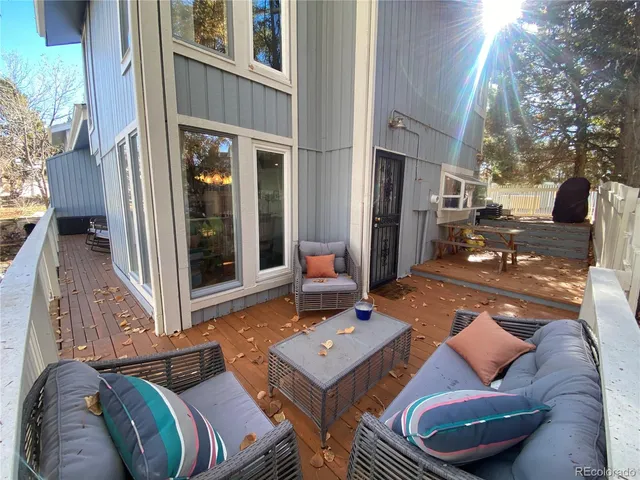 a view of a patio with couches table and chairs and potted plants