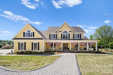 a front view of a house with swimming pool having outdoor seating