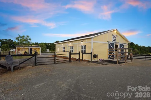 a front view of a building with play ground and trees