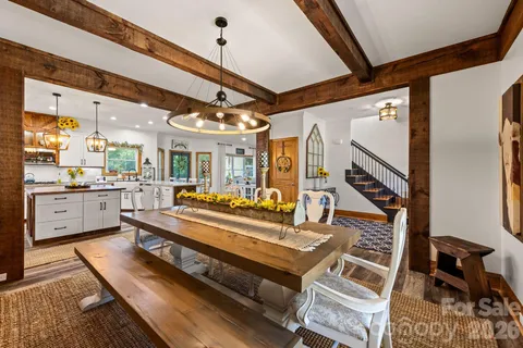 a large kitchen with a table and chairs