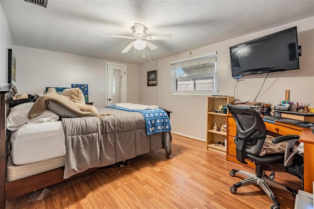 3608 Umber Road Holiday, FL 34691 - Photo 13 of 20 a bedroom with a bed and wooden floor