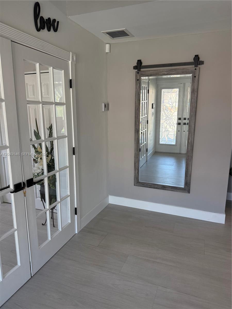 4947 Southwest 143rd Avenue Miami, FL 33175 - Photo 1 of 19 The entrance foyer with recreational room to the left.